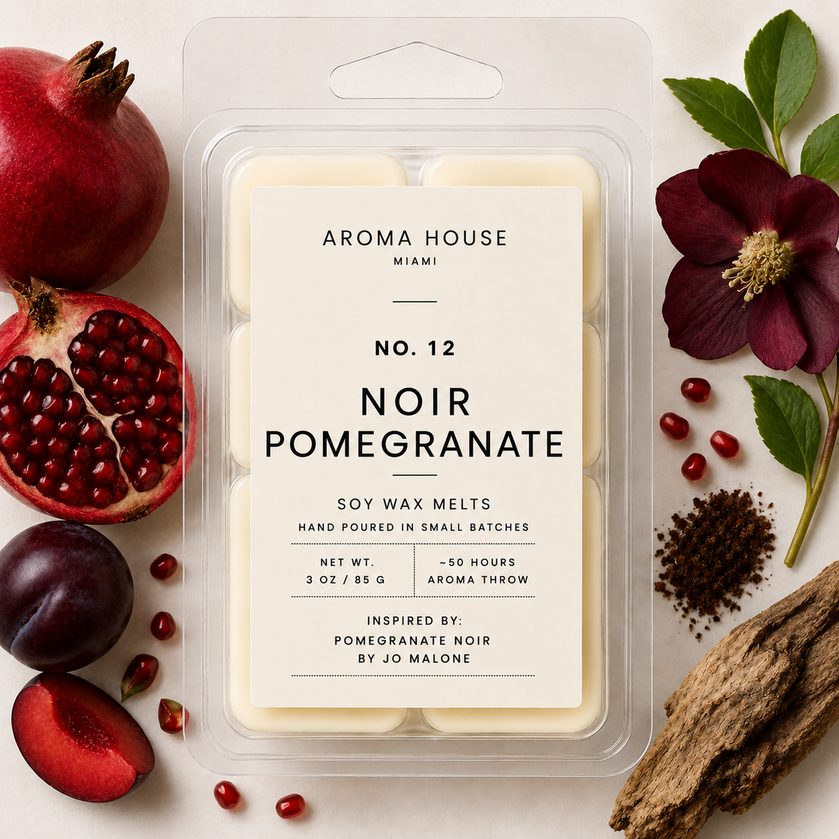 Noir Pomegranate soy wax melts by Aroma House Miami, 3 oz clamshell surrounded by pomegranate, clove, cedarwood