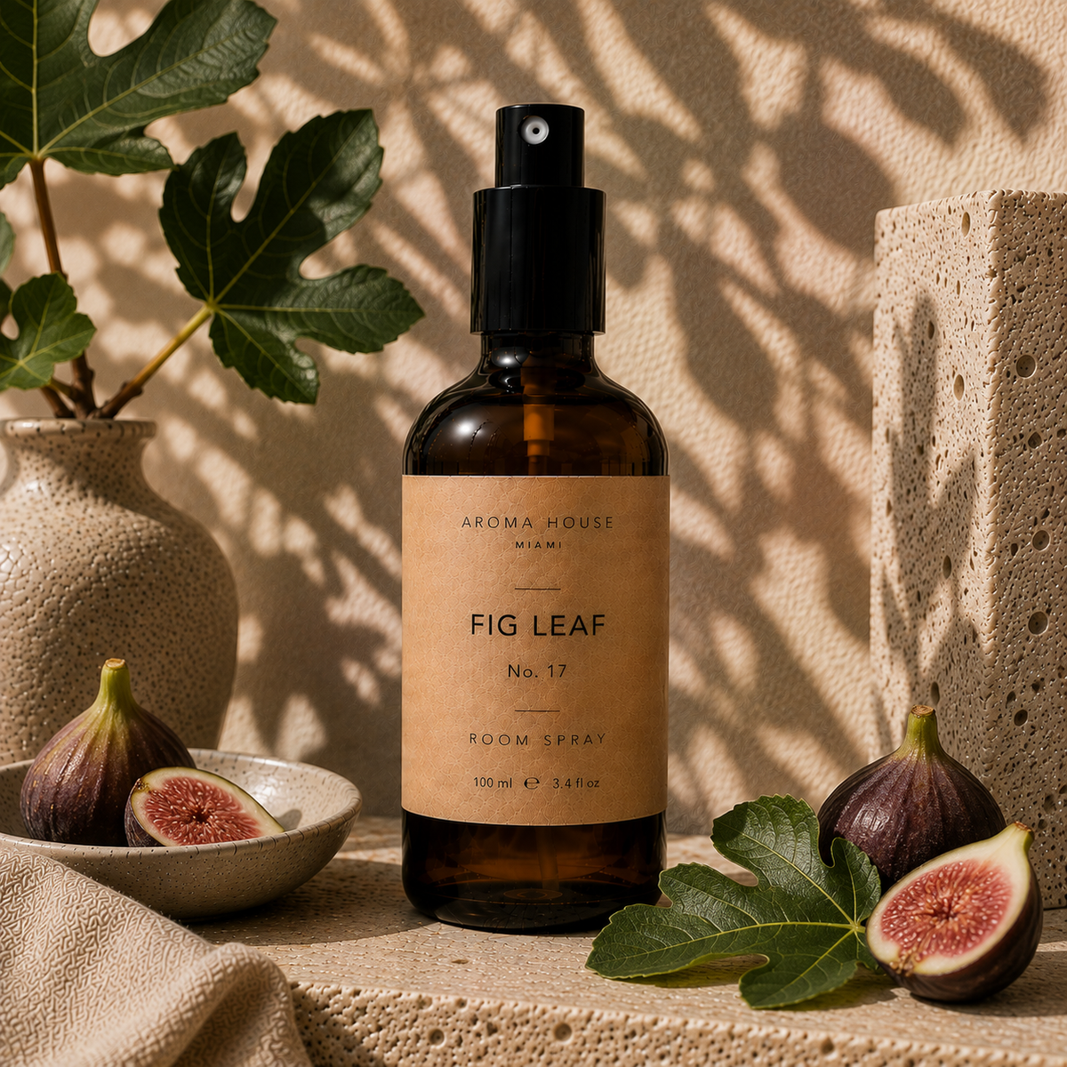 Fig Leaf room spray in amber glass bottle styled on a stone shelf, Aroma House Miami